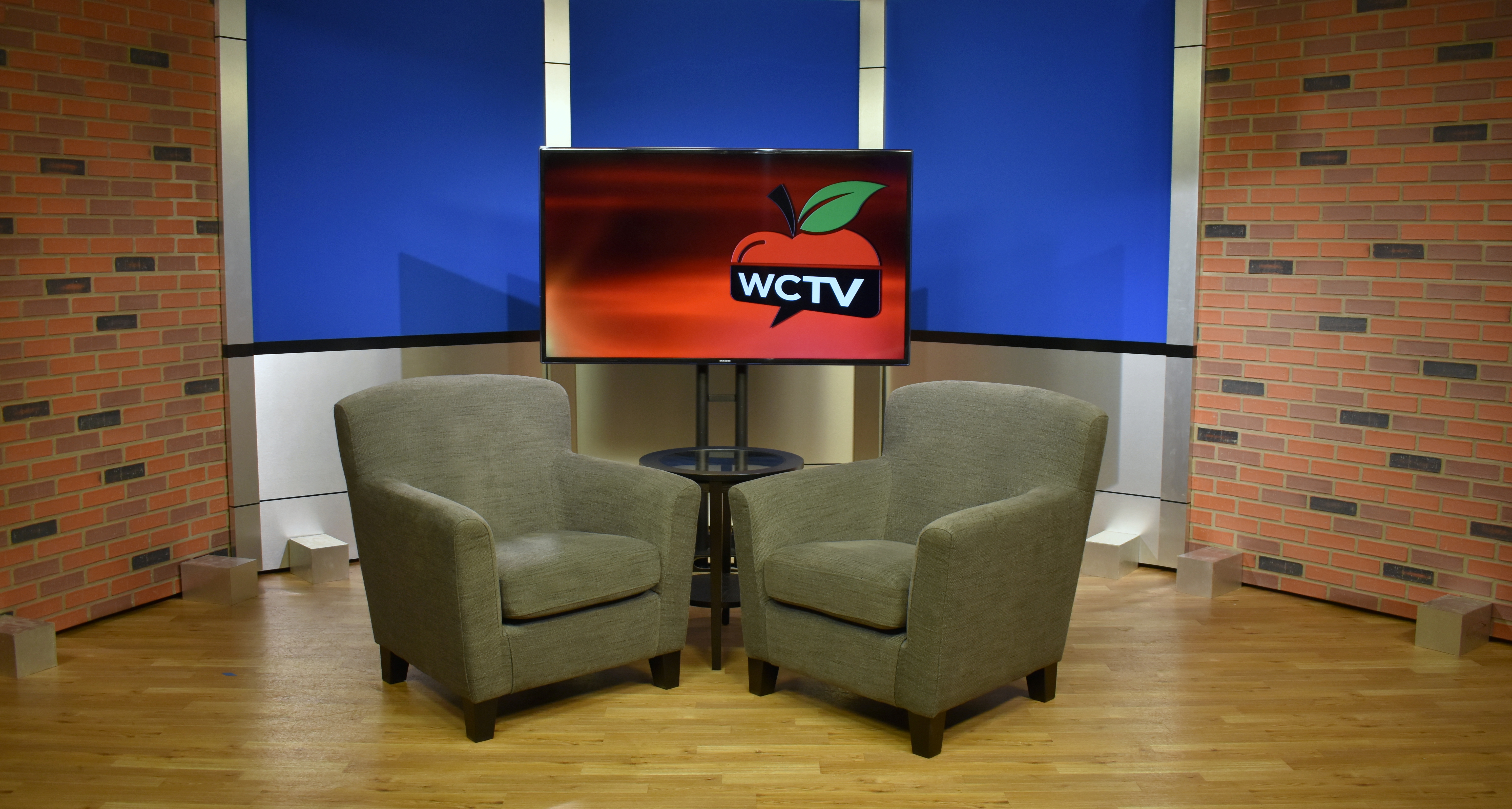 Back and aluminum set background with two chairs for casual interview style news broadcast productions