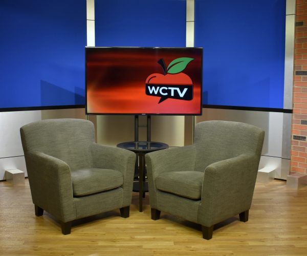 Back and aluminum set background with two chairs for casual interview style news broadcast productions