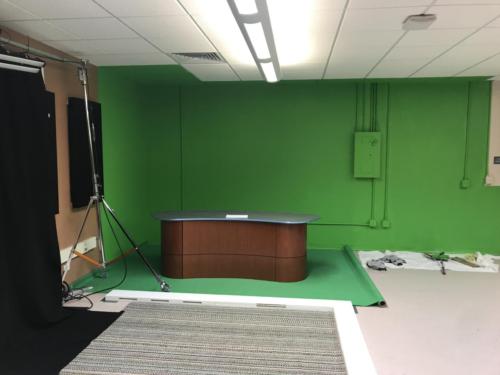 Curved anchor desk and green screen 