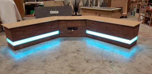 Custom Transition Panel Desk with Faux wood skin and blue LED lights 