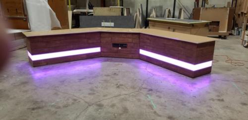 Custom Transition Panel Desk with Faux wood skin and purple LED lights 